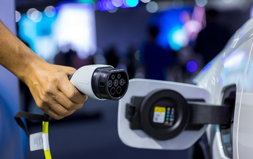 hand holding electric car charger electric vehicl 2022 11 16 14 02 45 utc